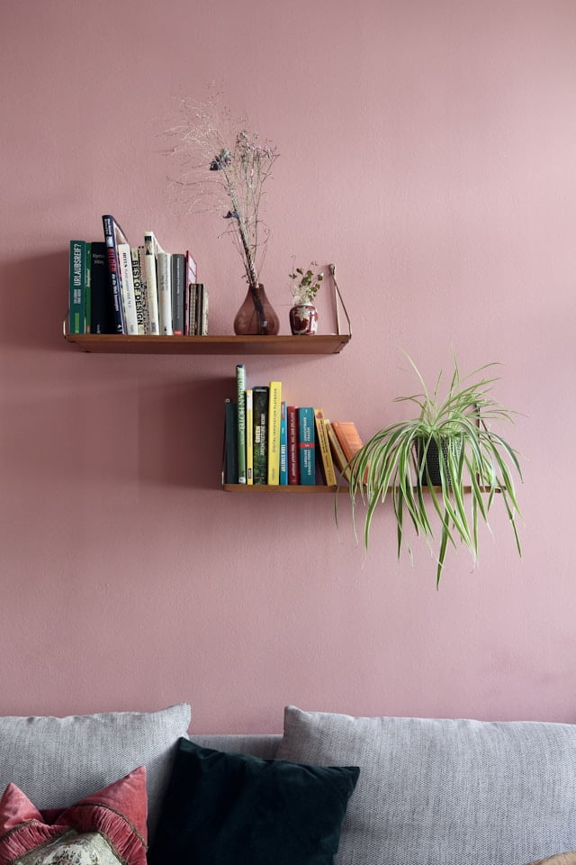 floating bookshelf styles with books and pink wall