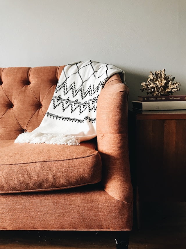 rustic home decor orange couch with white throw blanket