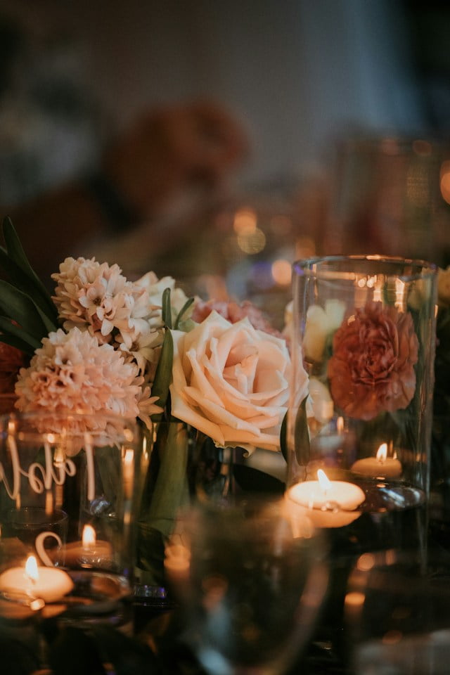 Spring coffee table decor assortment of candles and flowers