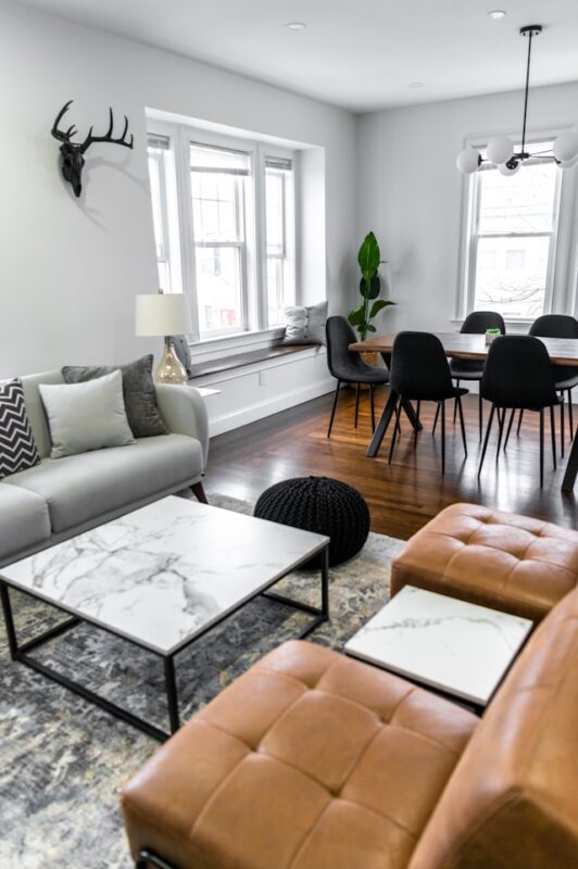 clean living room with gray area gray and brown leather chairs