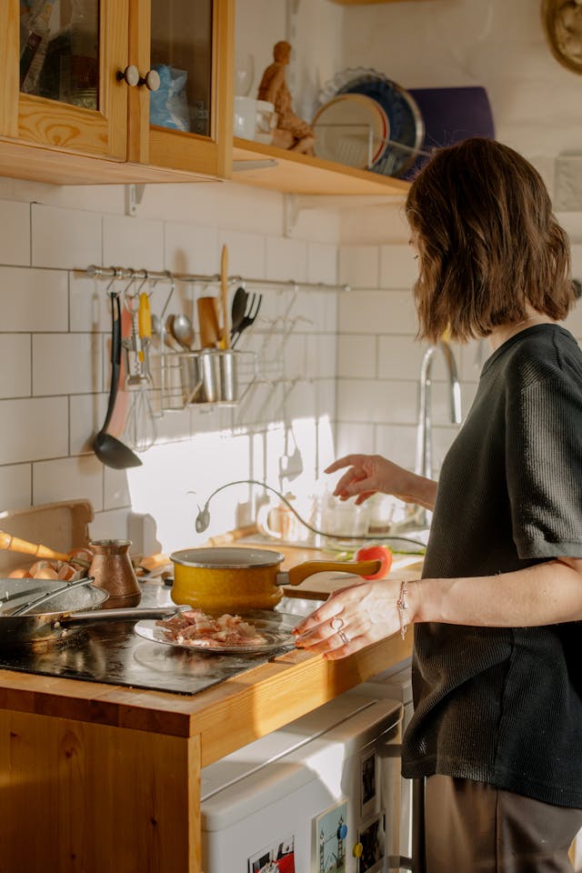 women cooking in kitchen with wooden cabinets