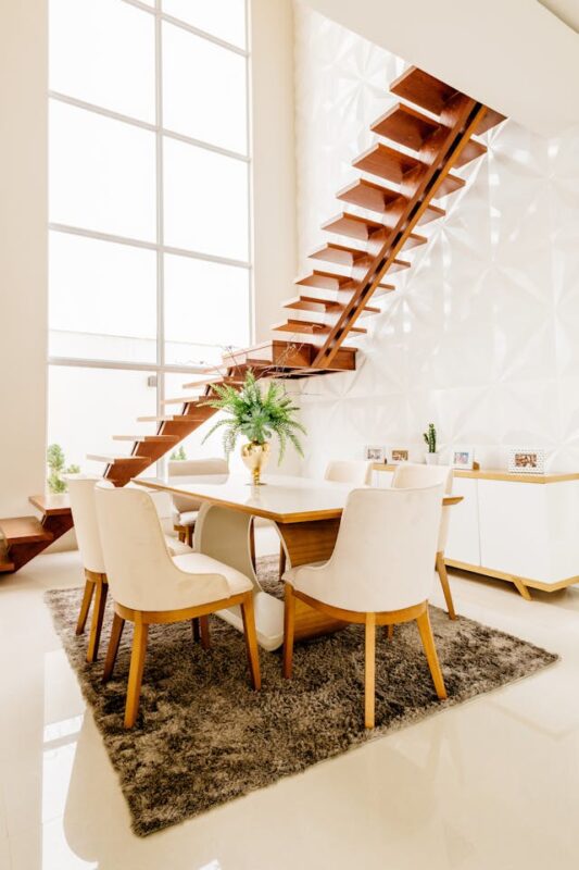 clean dining room underneath wooden stairs