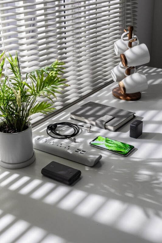 charging area on top of counter with electronics and cords