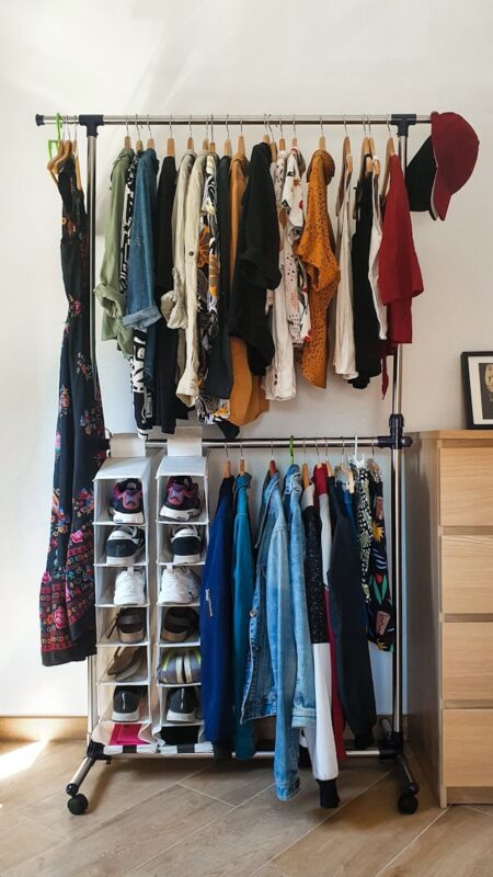 organized rack closet with clothes and shoes