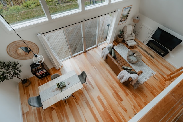 Overview of living room with hardwood floors and leather couch