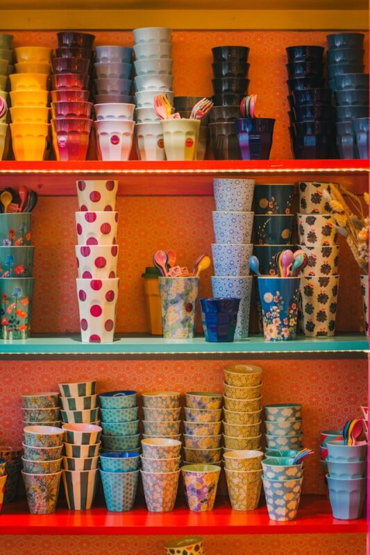 collection of colorful glasses on bright shelves 