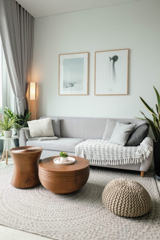 white and cozy living room with wooden accent tables