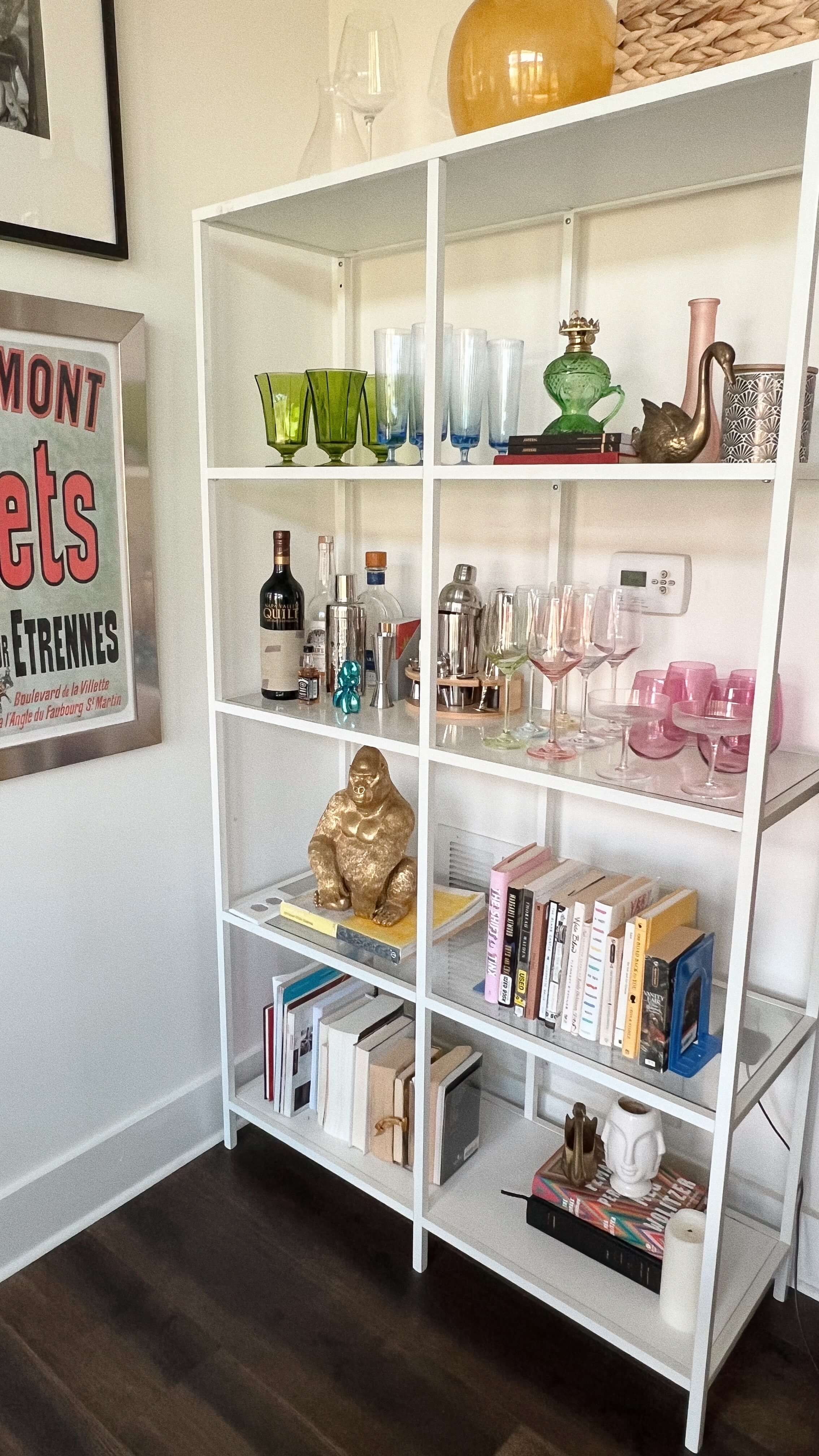 maximalist white bookshelf with colorful accents 