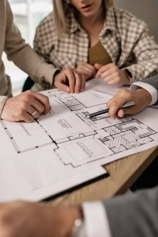 people planning home renovations with blueprints 