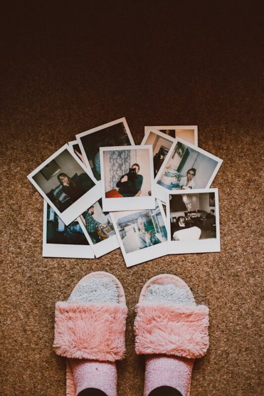 college care package comfy pink slippers next to pictures 