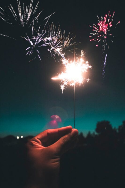 labor day party ideas and person holding a lit sparkler