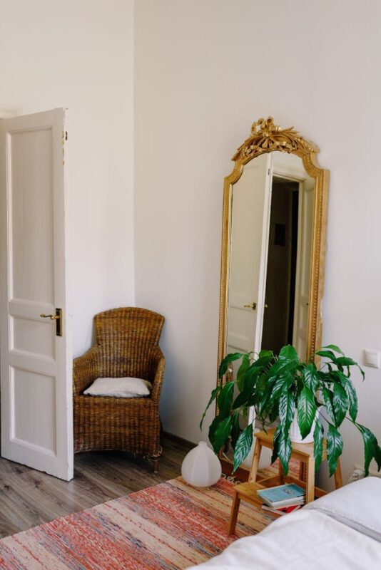 large wall decor with standing gold mirror and brown chair