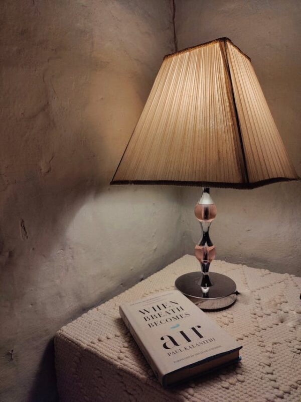 dim table lamp sitting next to book