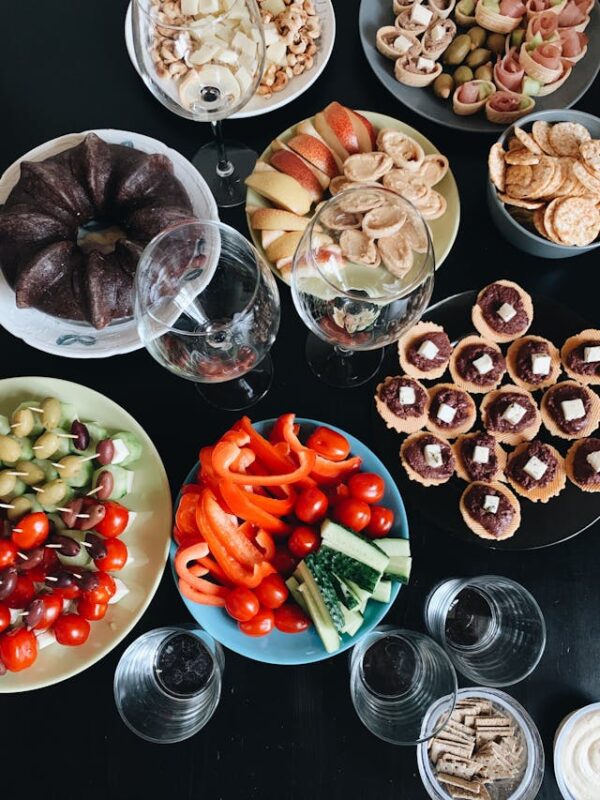 various colorful food dishes arranged in a potluck style 