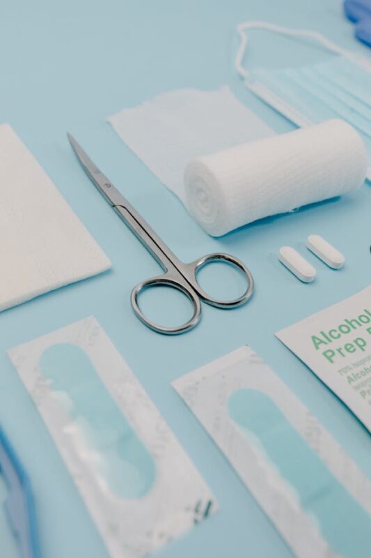 medical supplies laid out on blue plastic sheet 