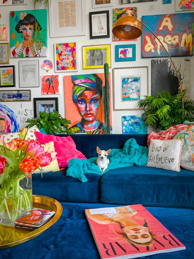 maximalist decor ideas of gallery wall and blue couch with small dog