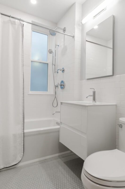 minimalist square mirror in white bathroom 