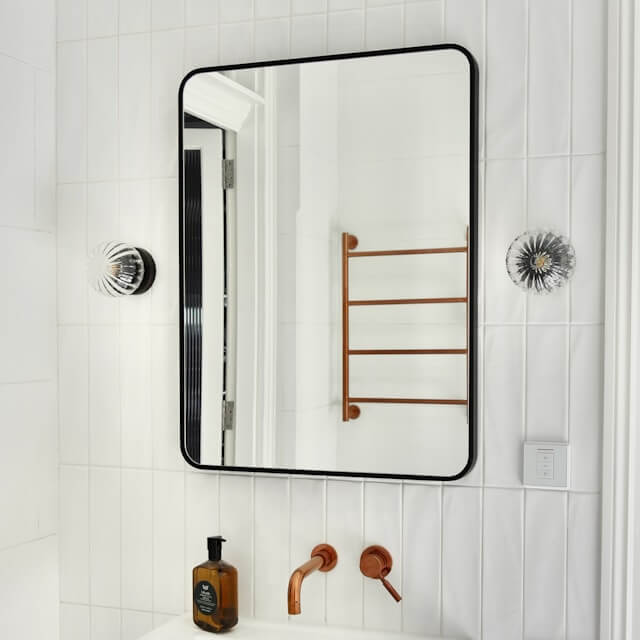 black framed rectangle bathroom mirror with rounded corners